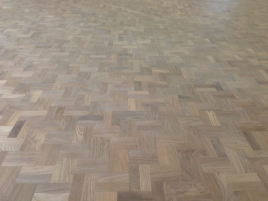 Close up of the Walnut Double Herringbone parquet floor prior to 1st sealer coat being applied